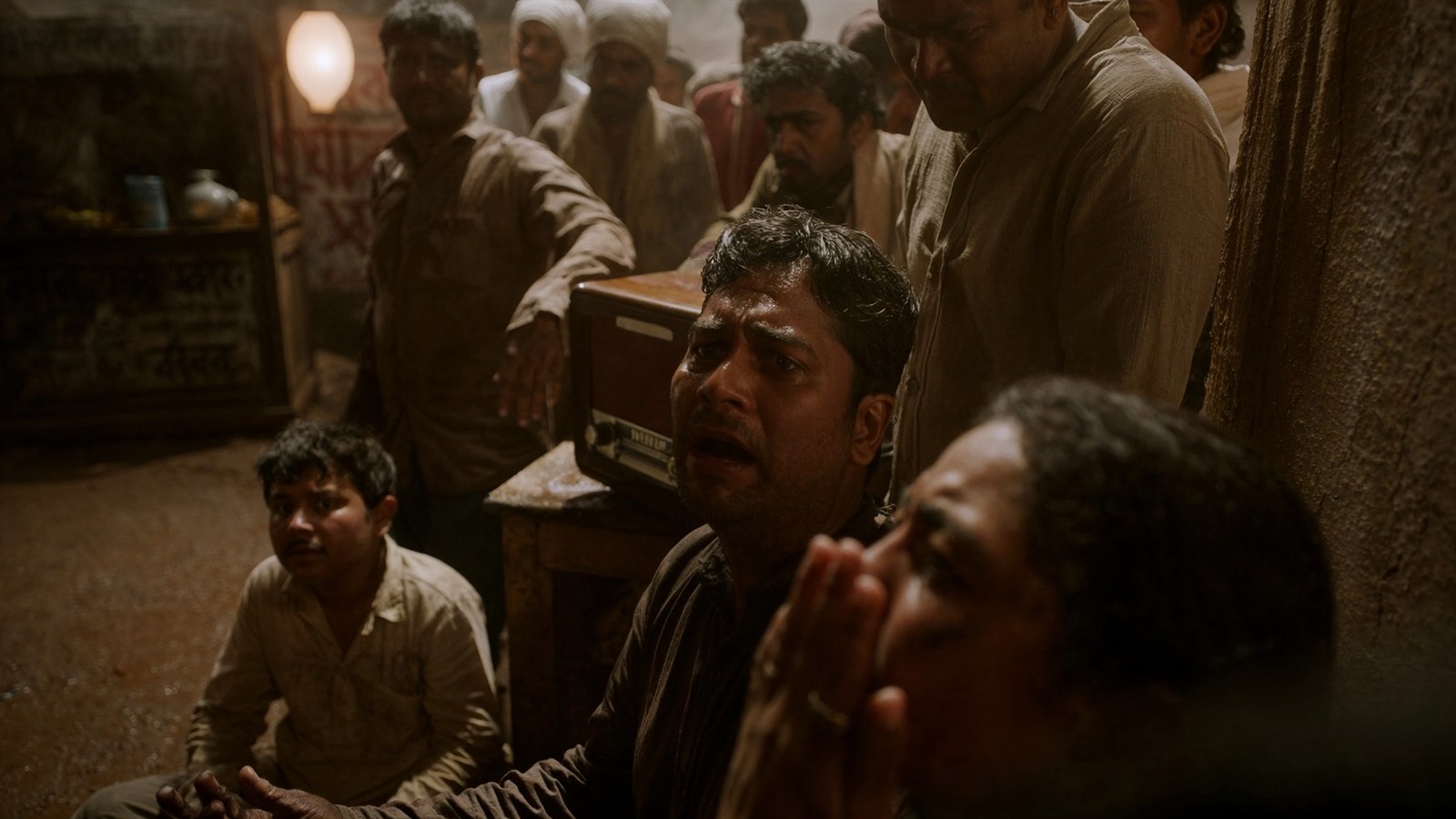Vande Mataram ending frame with a shocked listener reacting beside a radio